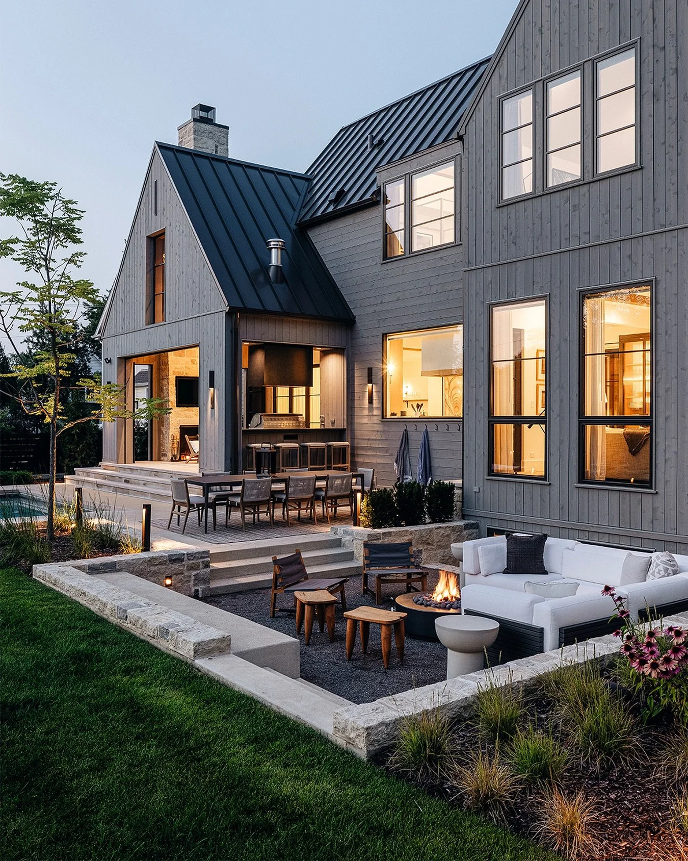 This outdoor sunken conversation pit is a beautiful example of design meeting function. This feature brings a closer eyeline to the landscape and allowed for a large window well to pour natural light into the home&rsquo;s lower level. And of course, 