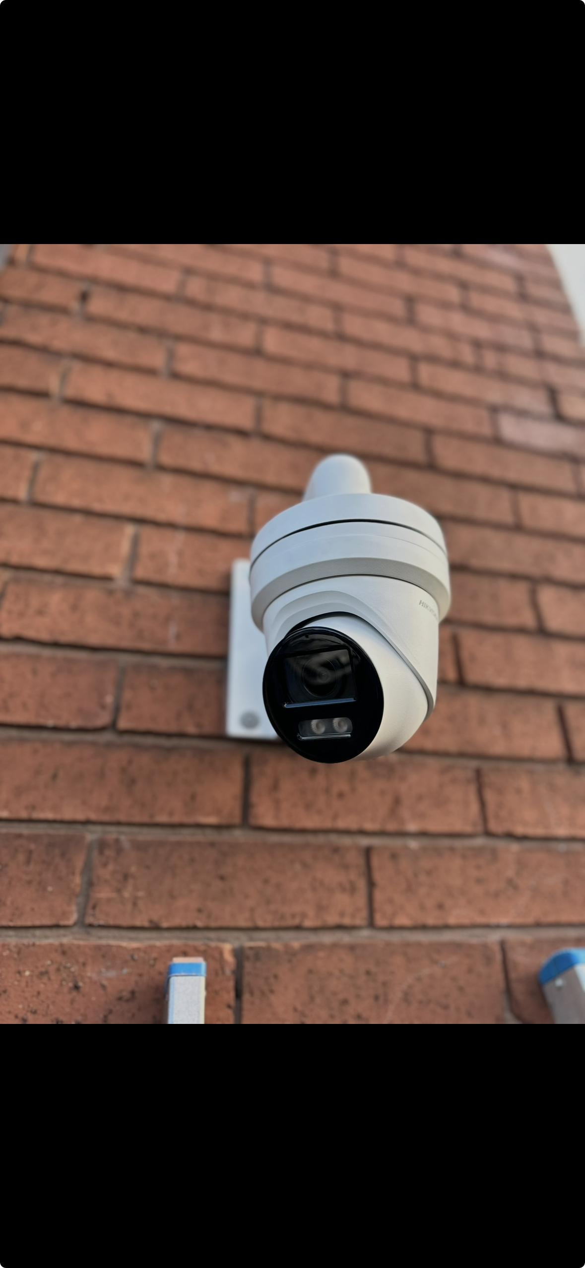 Security camera mounted on a brick wall