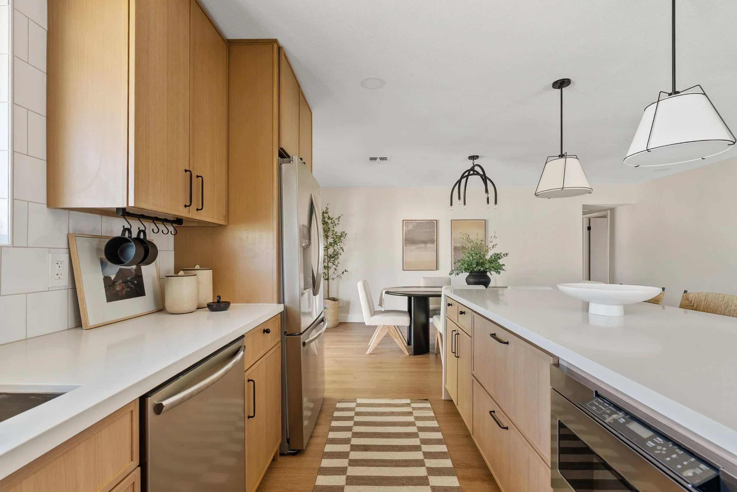 A modern organic open concept kitchen and dining area of a home.