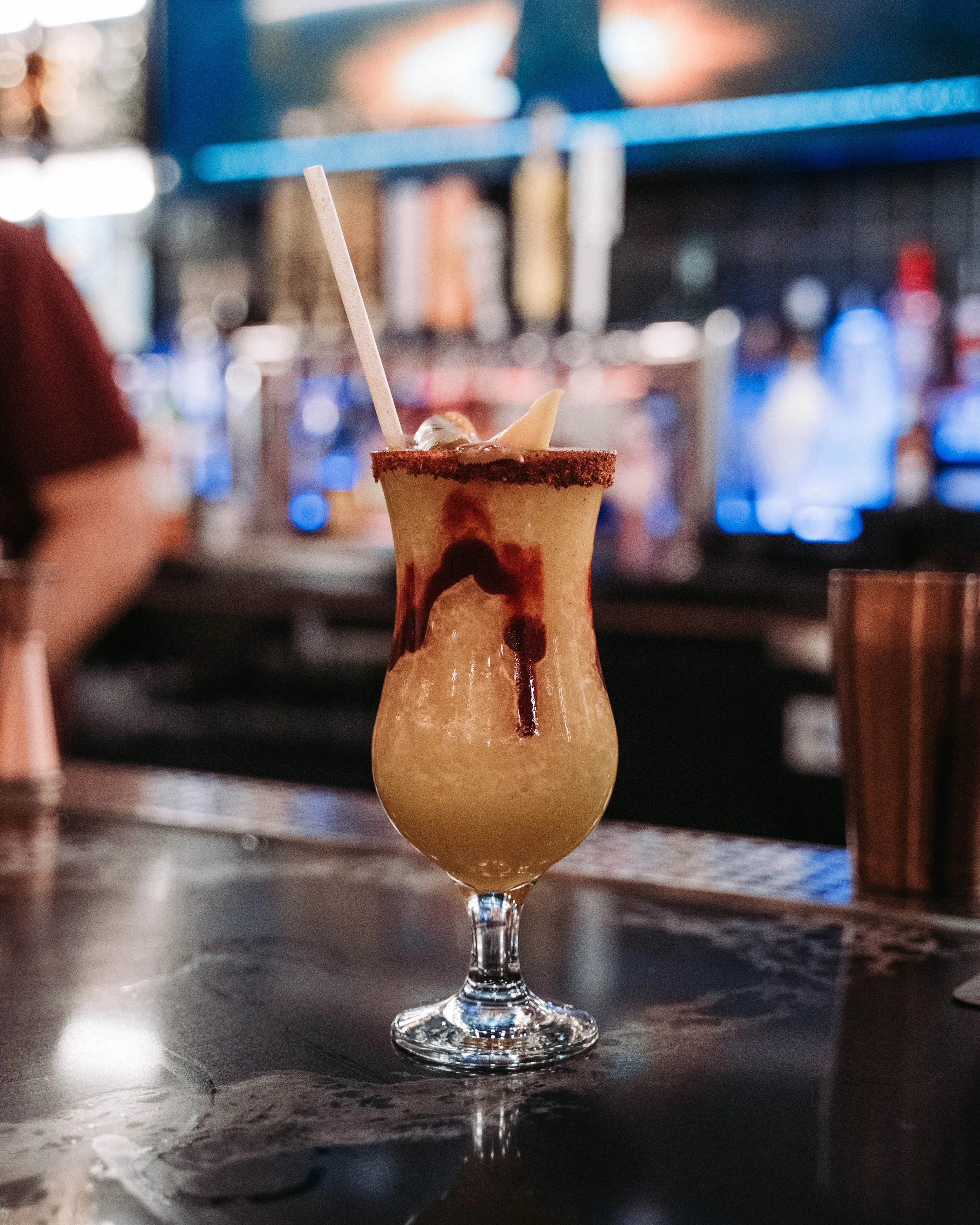 Mangonada cocktail with chamoy and tajin rim at Raul's Tequila & Kitchen