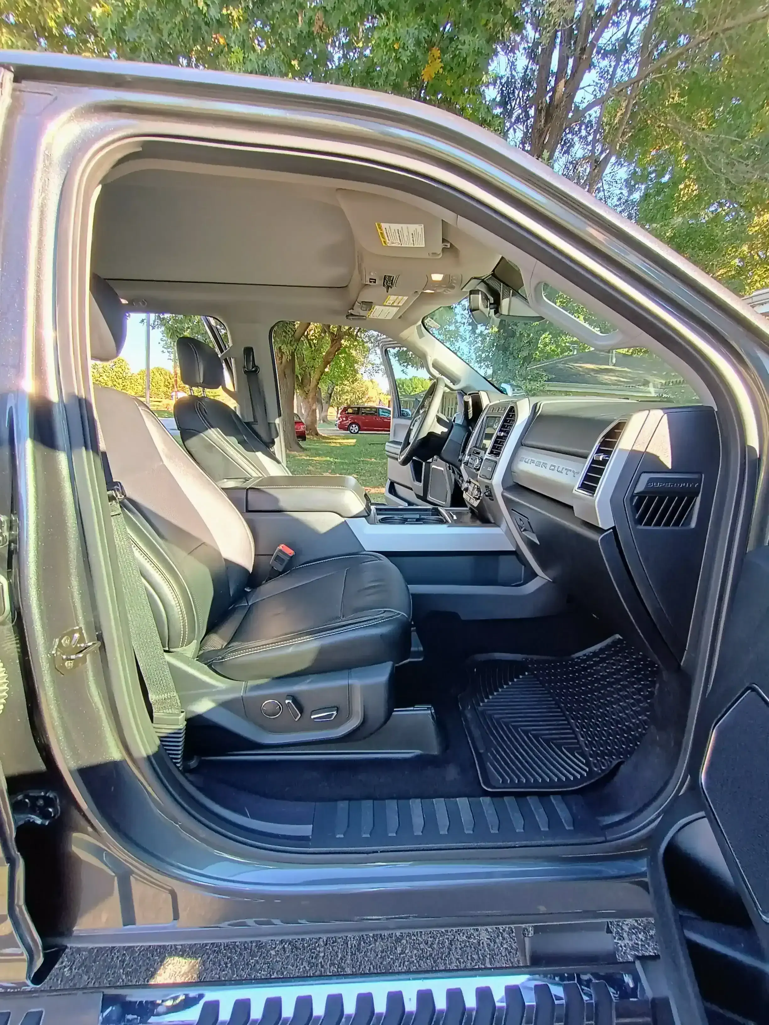 Interior detailing results in Willard, MO showing a freshly cleaned truck cabin with spotless seats and trim visible through the open passenger doo
