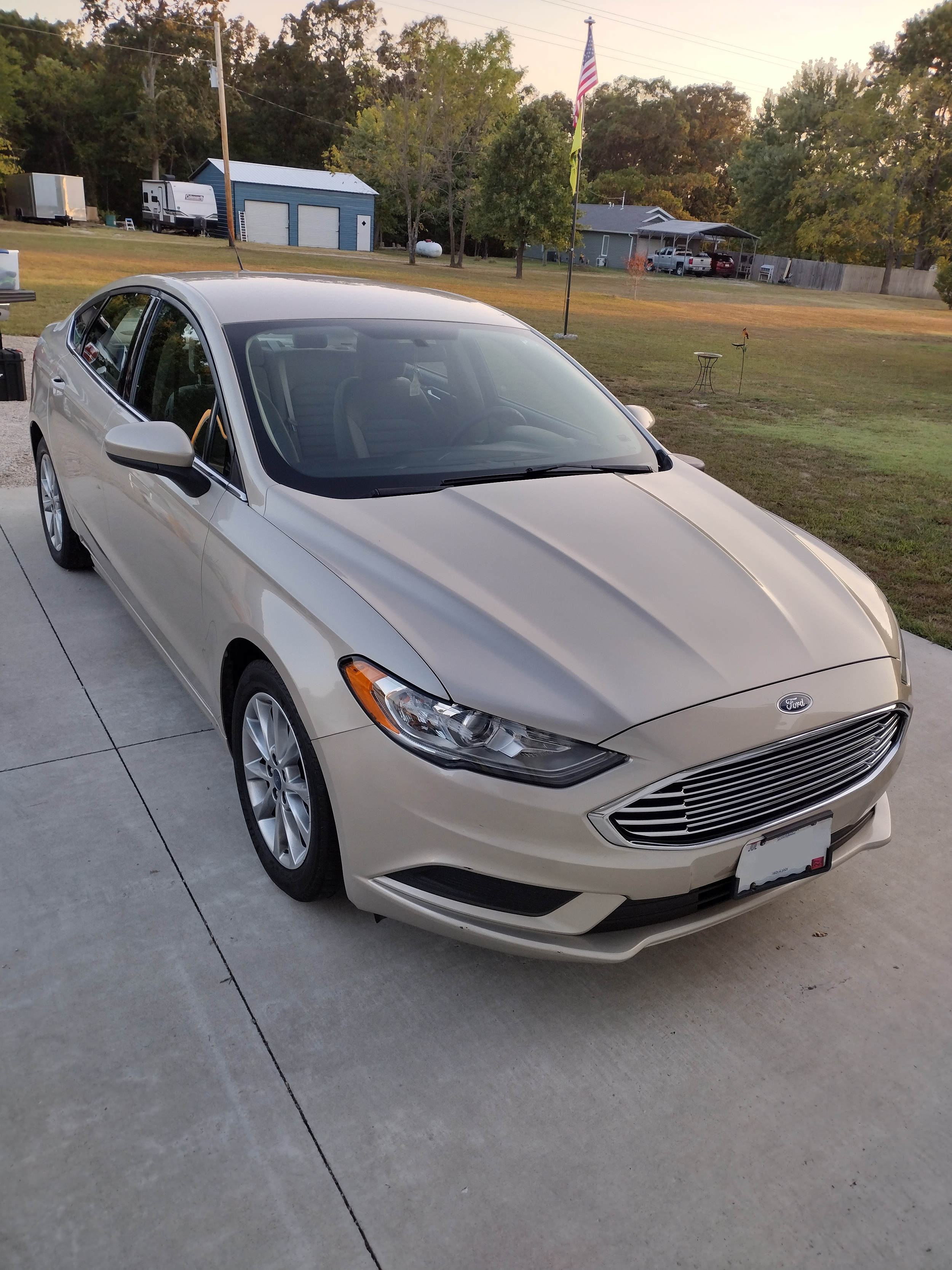 Professional exterior car detailing results in Springfield, MO showing a professionally cleaned sedan with a high-gloss finish