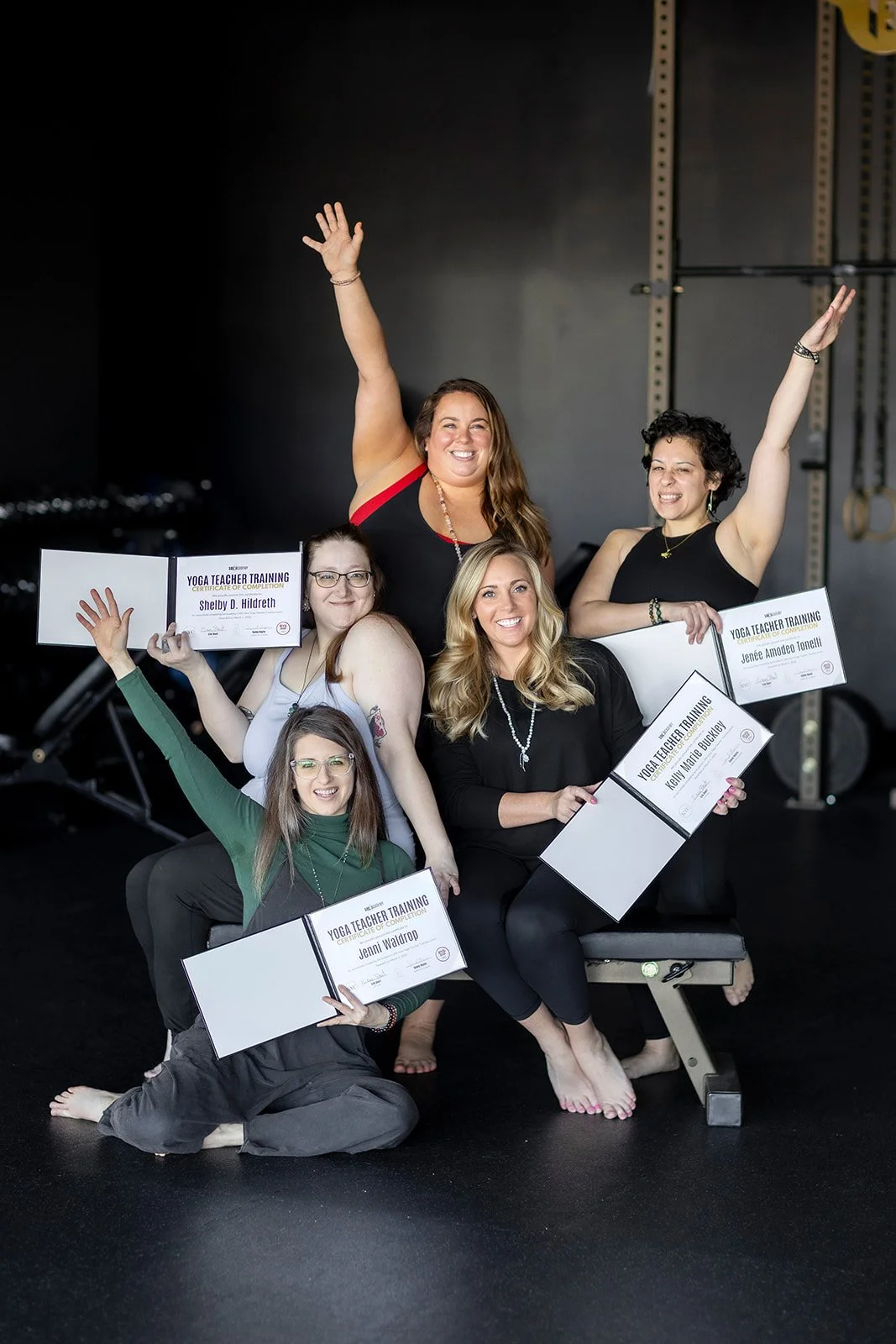 Graduates and instructor holding diplomas after completing Sol Academy’s 200-hour yoga teacher training in Lexington, Kentucky.