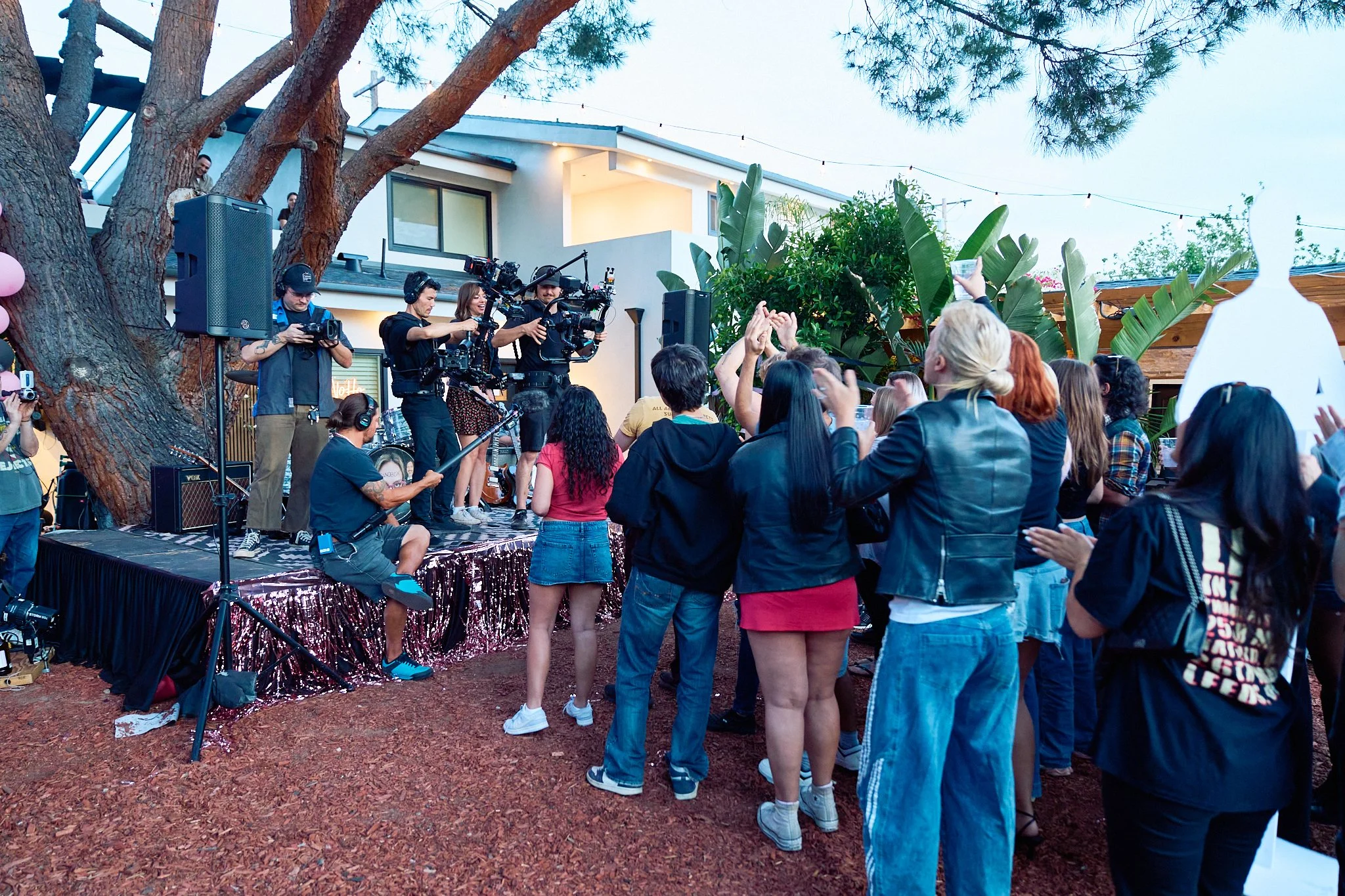 Unit stills photography, Super Fan vertical film, featuring The All-American Rejects, behind the scenes wide shot of cast, extras and crew members.