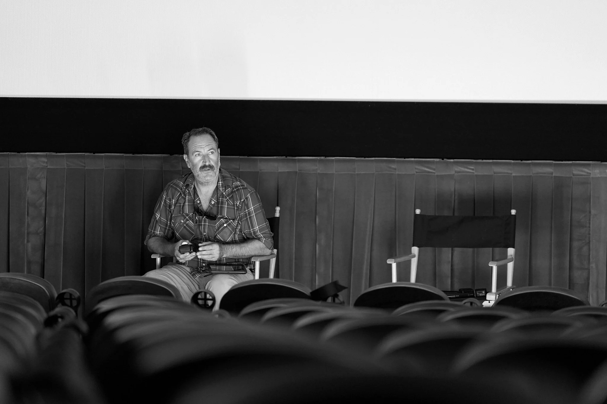 On-set unit stills photography, The Making of Jesus Diabetes, behind the scenes of the crew testing lighting inside a theater.