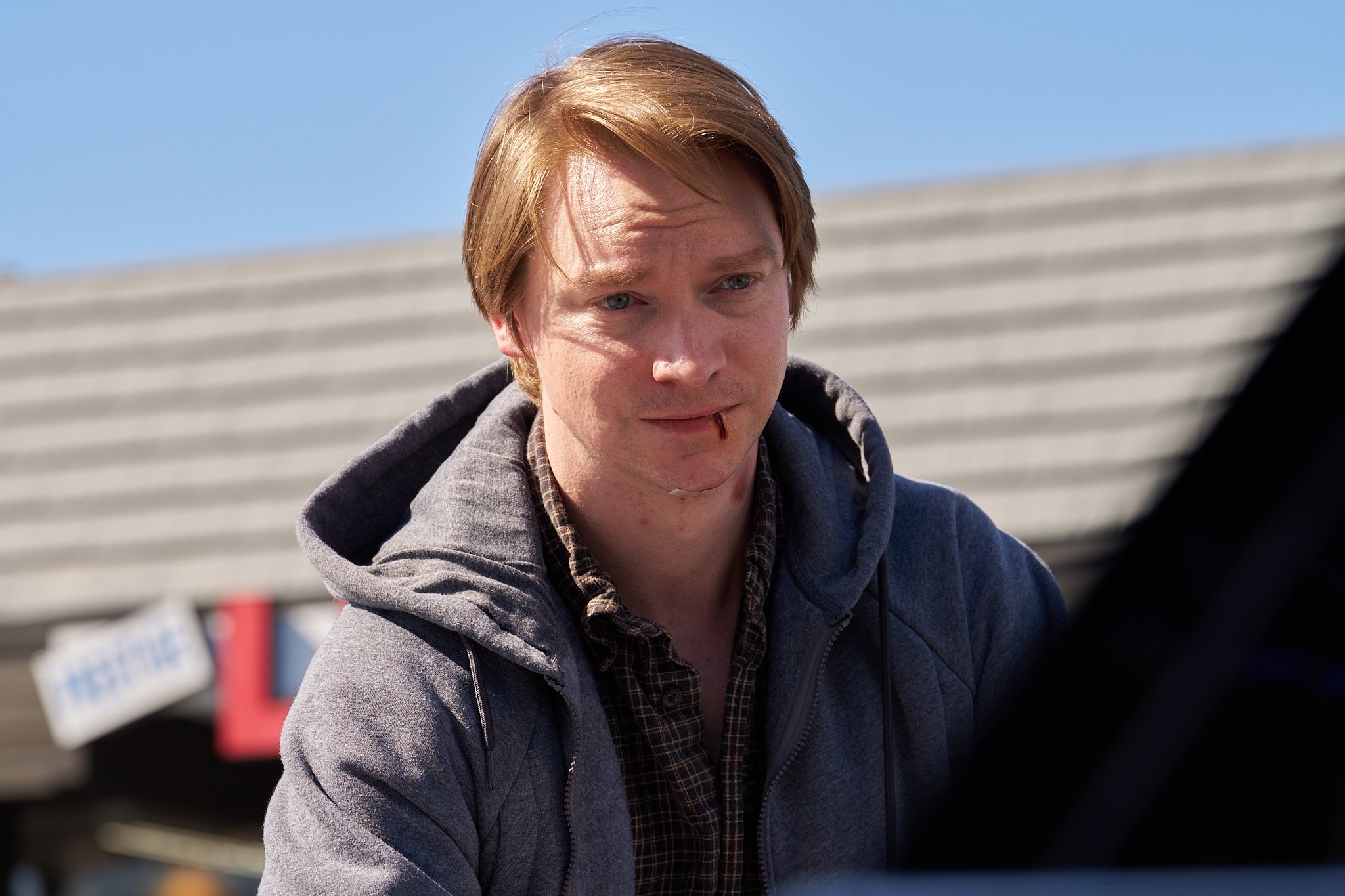 Unit stills photography, for the short film TEDDY, image of actor Calum Worthy in the liquor store parking lot scene.