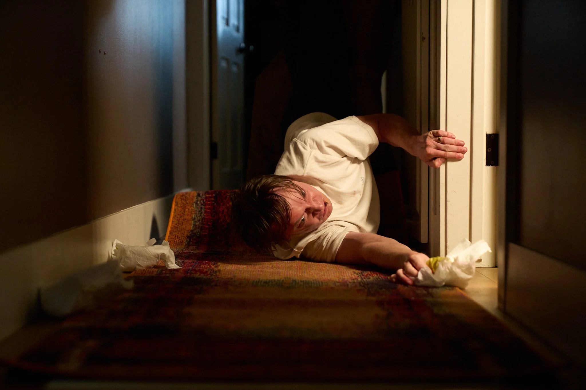 Unit stills photography, for the short film TEDDY, BTS image of actor Calum Worthy's character being dragged through hallway.