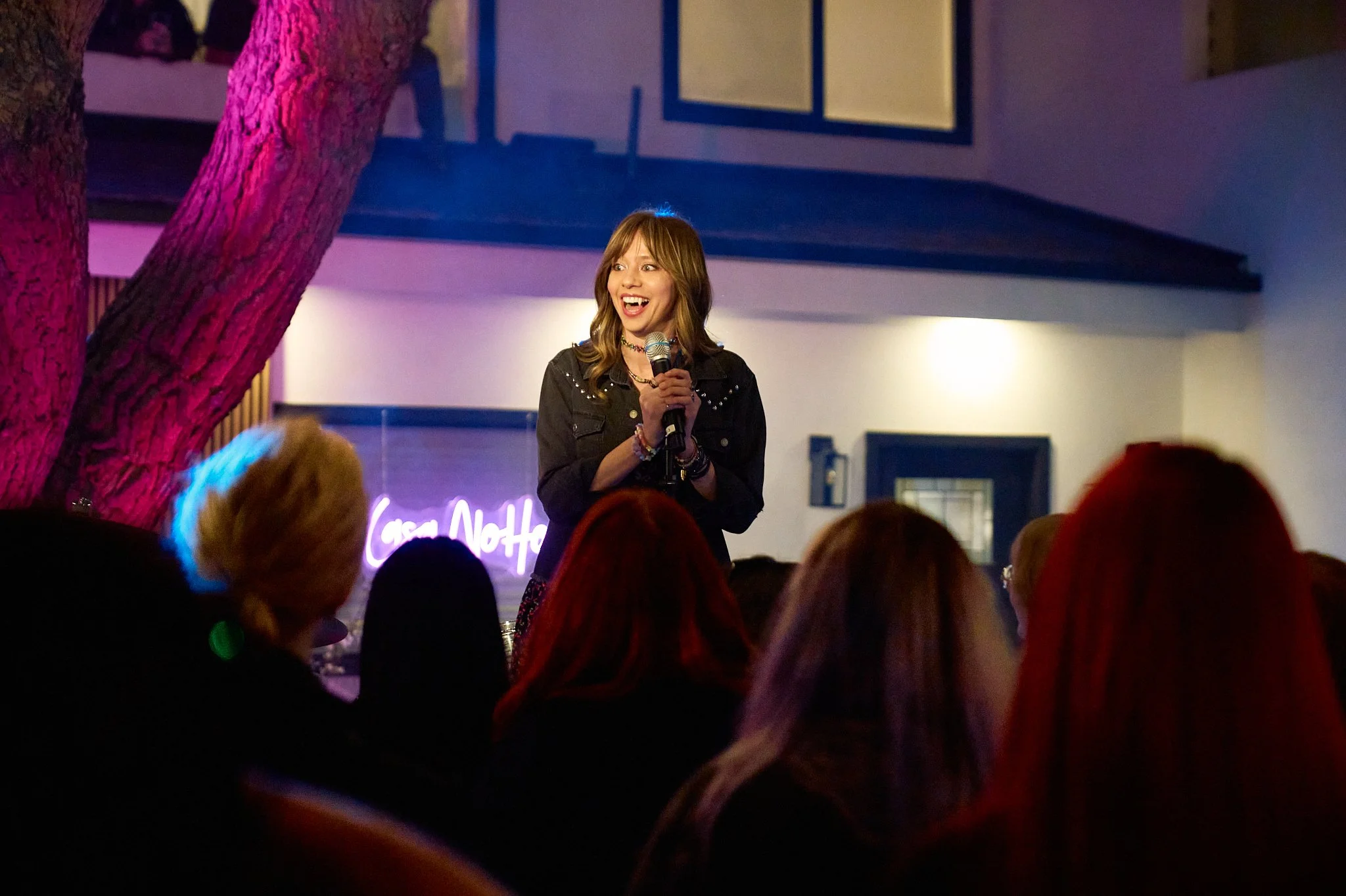 Unit stills photography, Super Fan vertical film, featuring The All-American Rejects. Actor Anna Lore in a scene where she welcomes the audience to the show.
