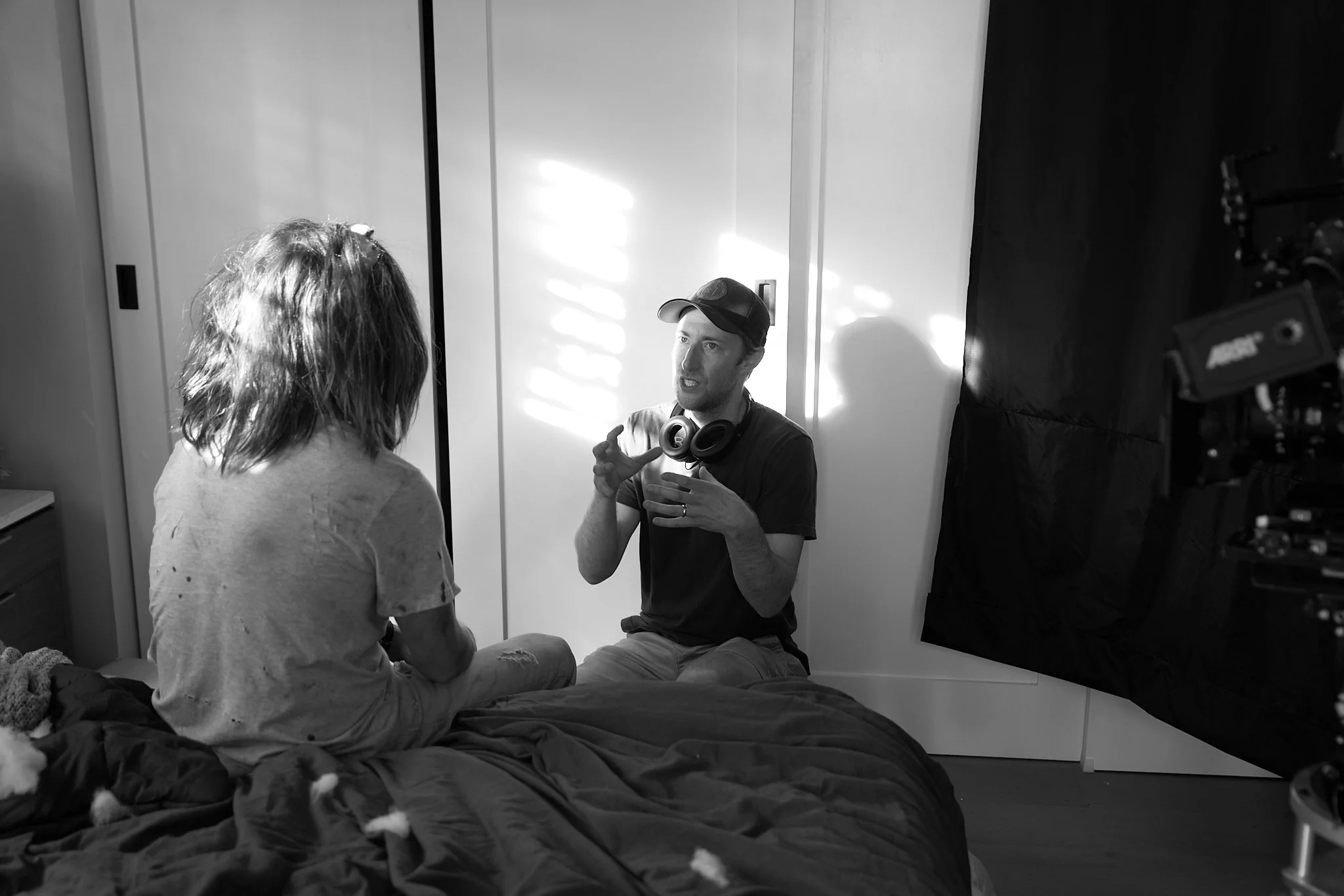 Unit stills photography, for the short film TEDDY, BTS image of director Jonathan Siebel and actor Calum Worthy on set for a bedroom scene.