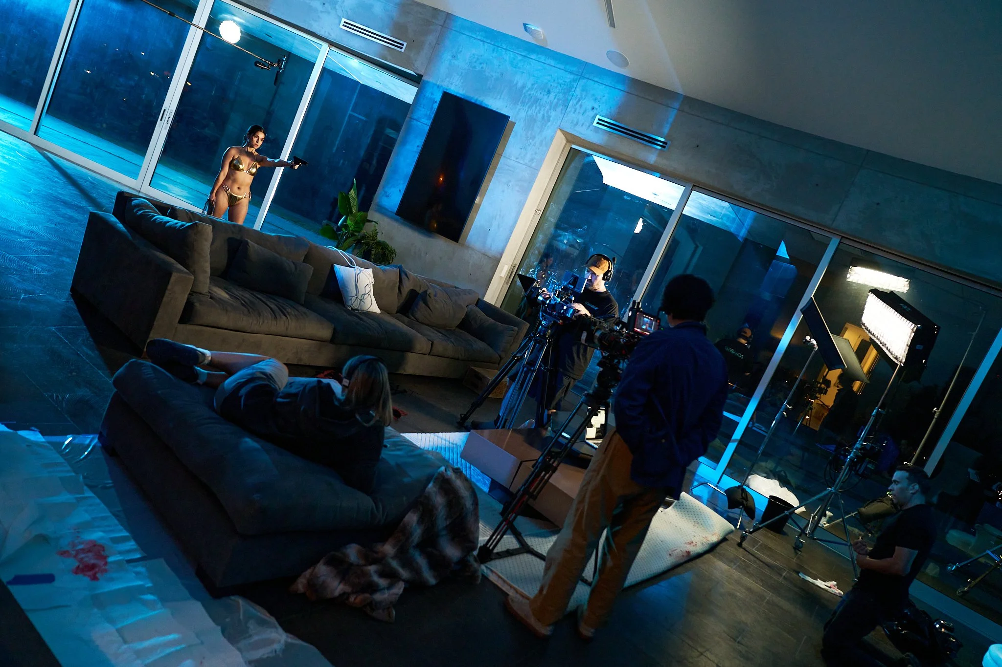 Unit stills photography, for the short film Doppelgänger, BTS wide shot image of actor Sabina Collazo holding a gun during a scene.