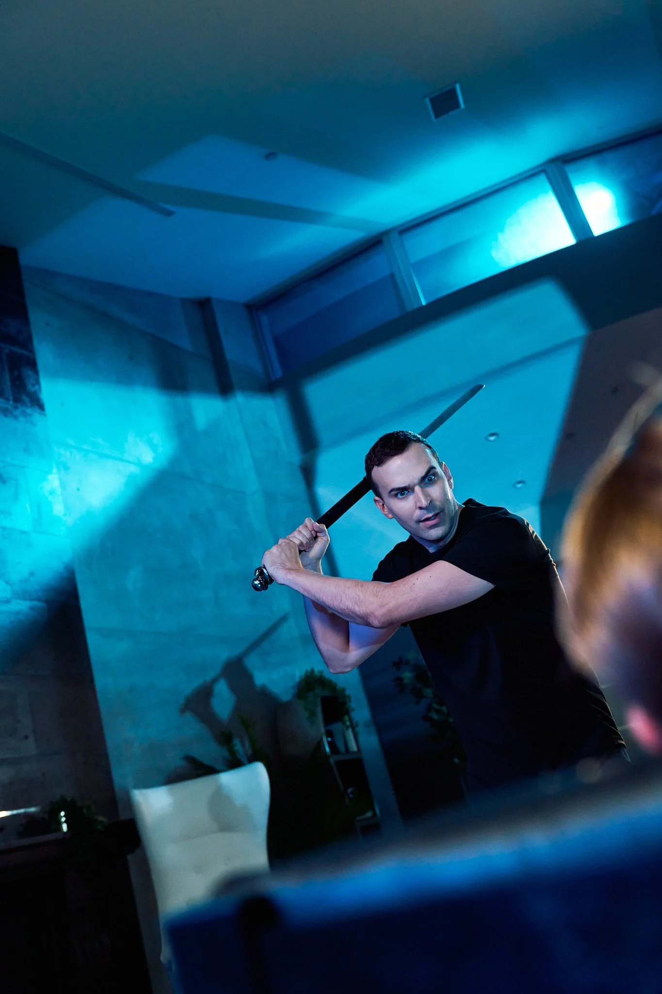 Unit stills photography, for the short film Doppelgänger, actor Mark Haan raises a sword in a scene.