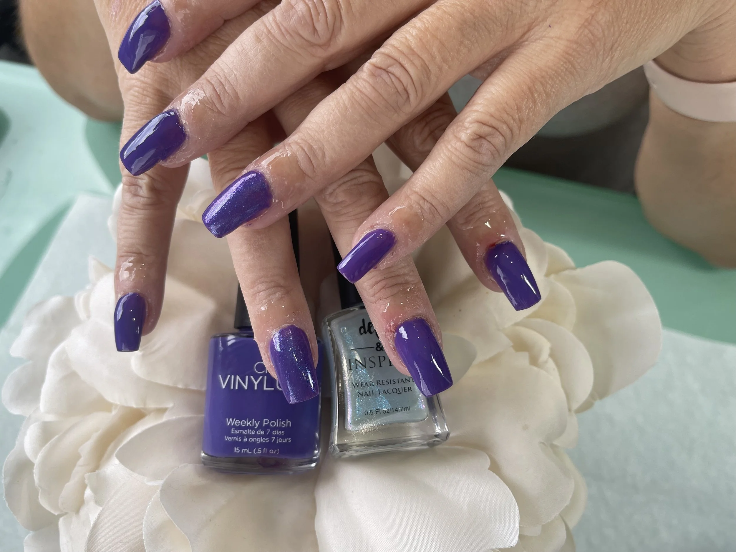 Acryllic Nails laying on nail polish
