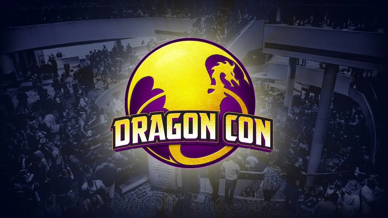 Logo for Dragon Con with a yellow and purple dragon in a circle, background shows a crowded convention center with many people.