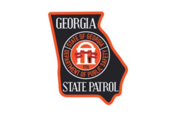 Georgia State Patrol emblem featuring a badge shape with a black background, white outline, and the text 'Georgia State of Georgia Department of Public Safety' around a central emblem with a gavel and date 1776.