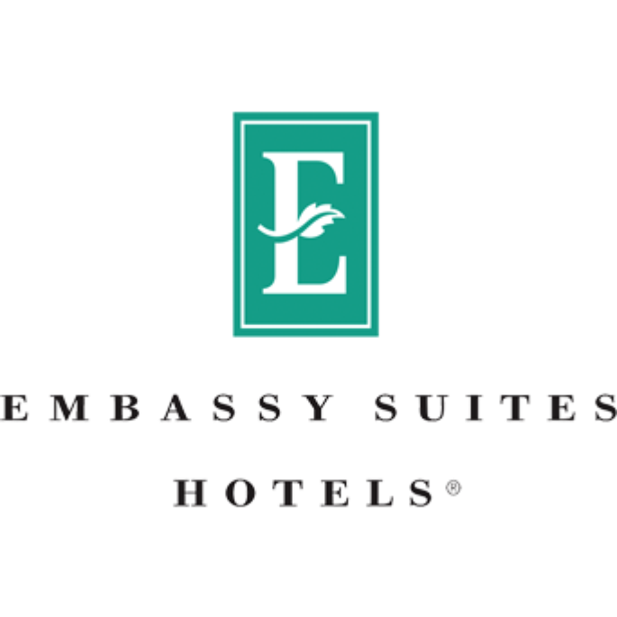 Embassy Suites Hotel logo with a teal square containing a white letter 'E' and palm tree icon, and the text "Embassy Suites Hotels" below.