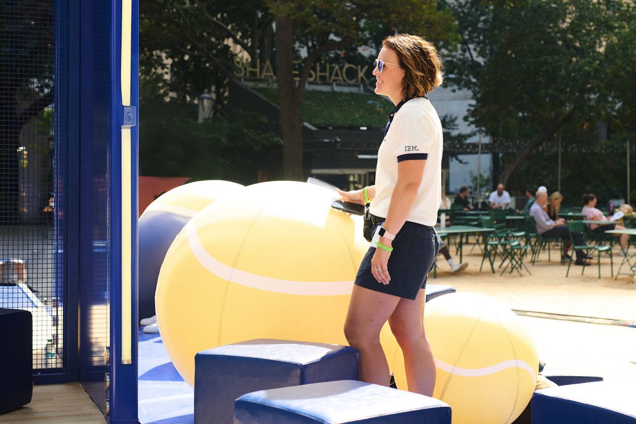 A woman dressed like a referee smiling at it's brand activation in Madison square park 