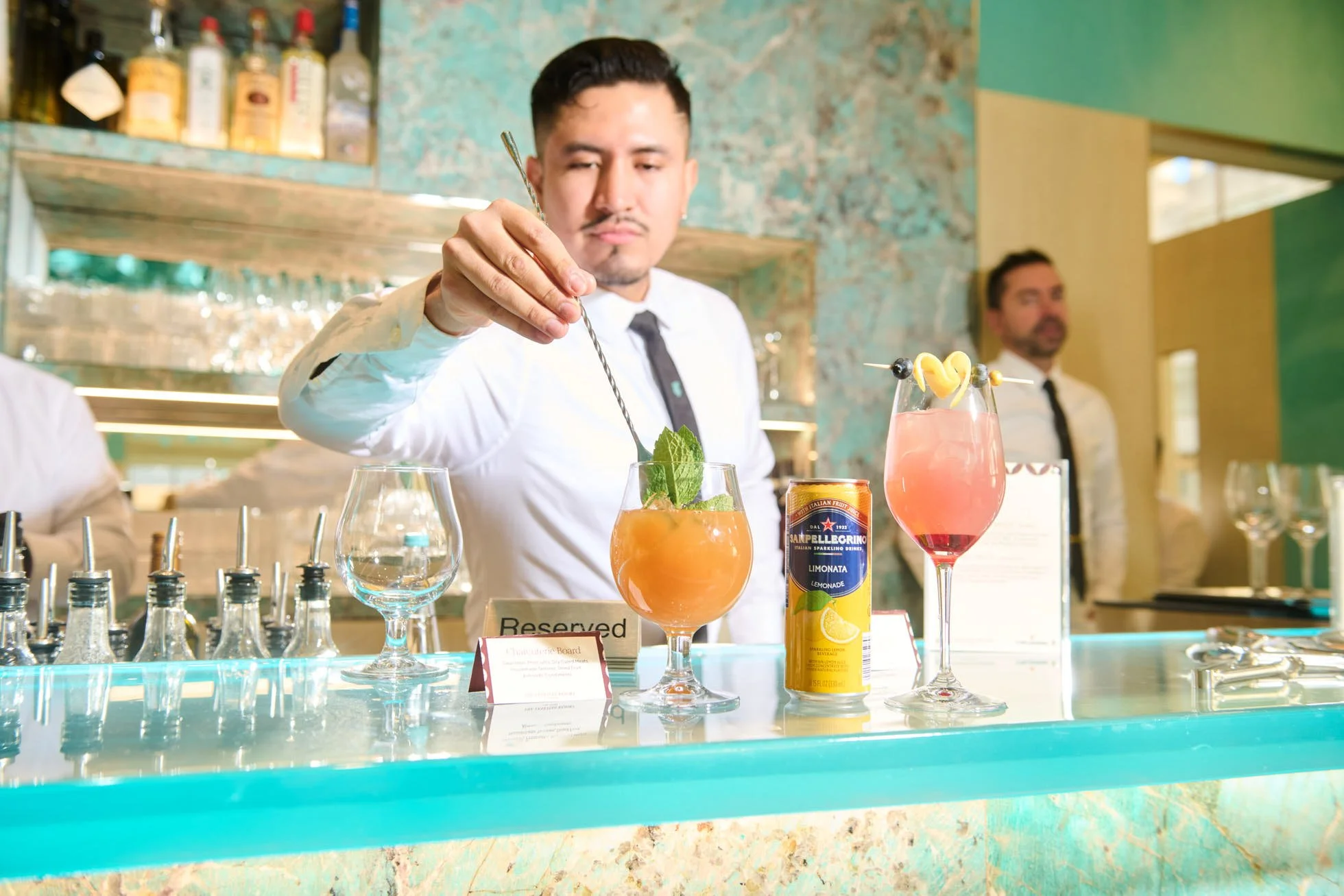 Bartender mixing drink with San Pellegrino for at Tiffany's