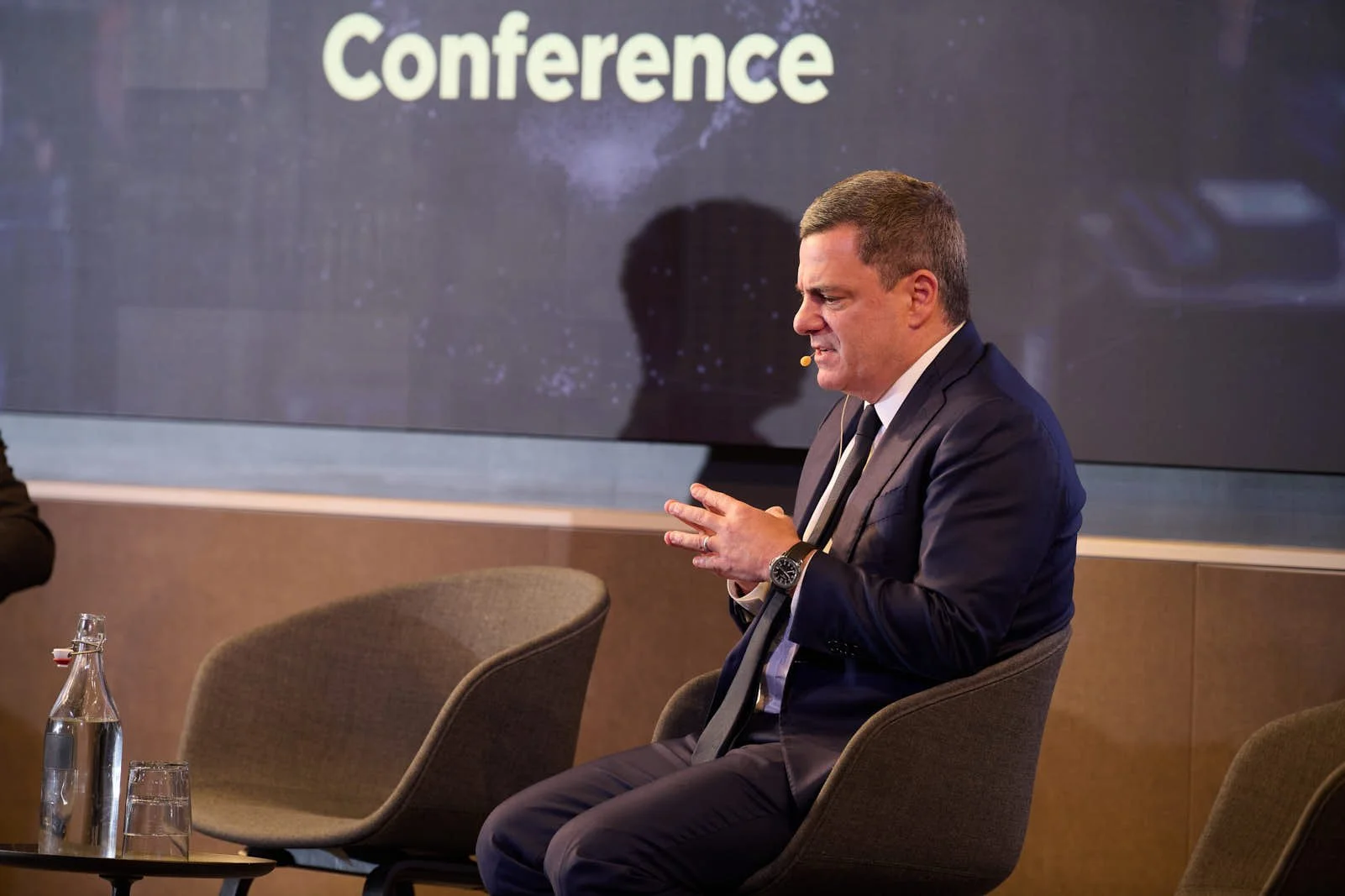 Jim Esposito of Citadel onstage looking deep in thought at the global exchange leader conference for Rosenblatt Securities 