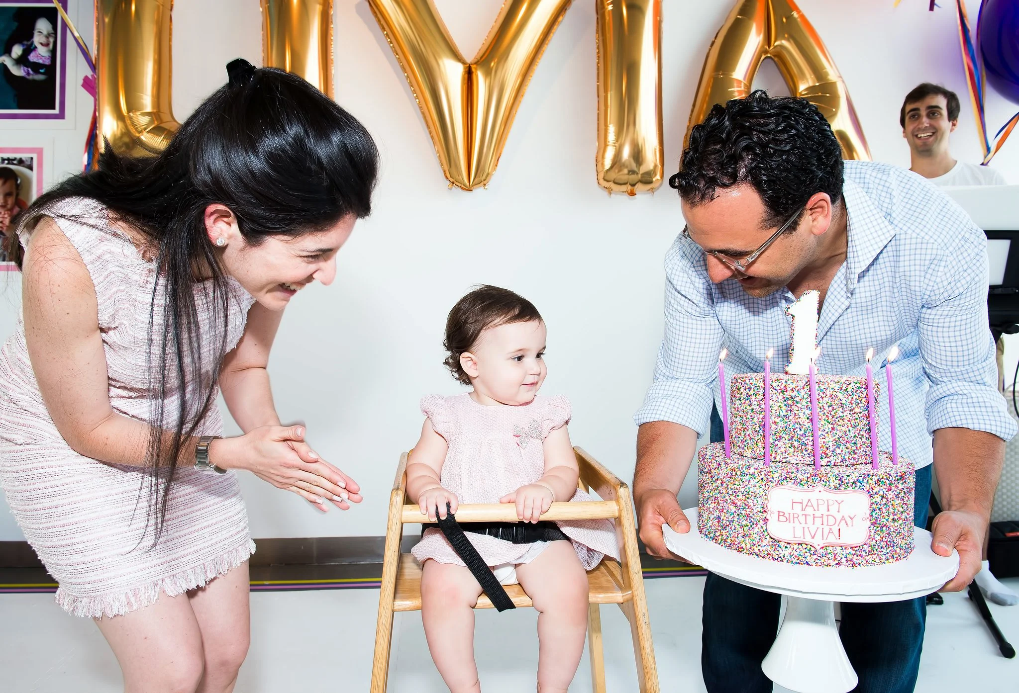 Lee Fixel and his wife, giving their daughter a cake on her first birthday. 