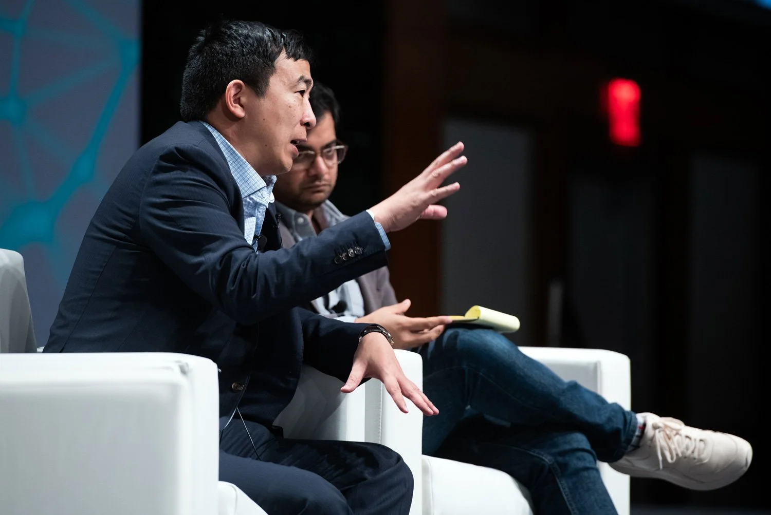 Andrew Yang speaking onstage at a panel for Consensus 2019