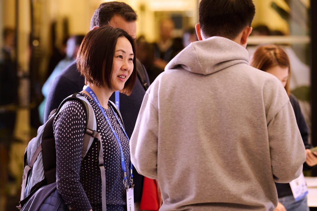 Attendee smiling during check-in at deeplearning.ai conference
