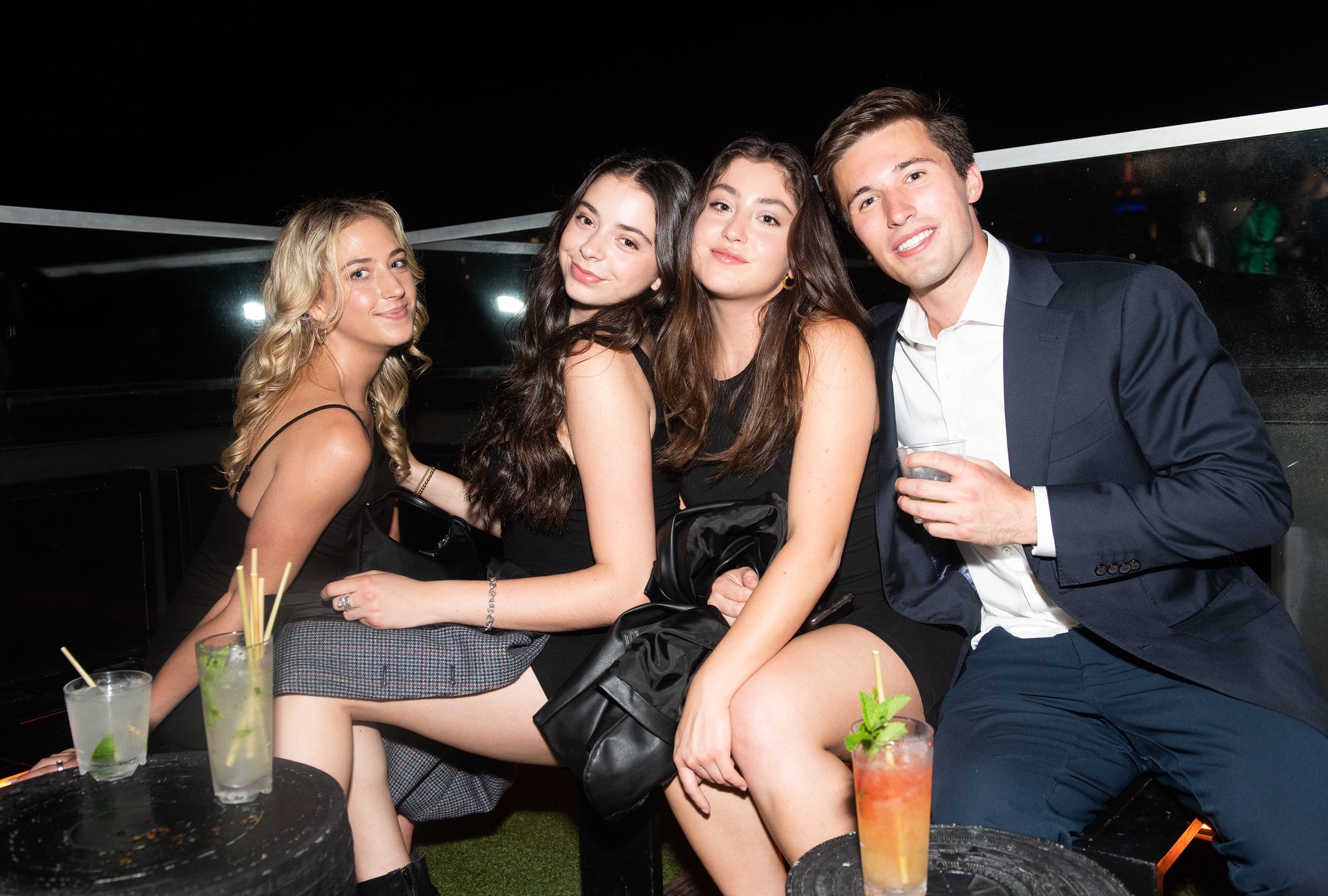 People smiling at a rooftop party