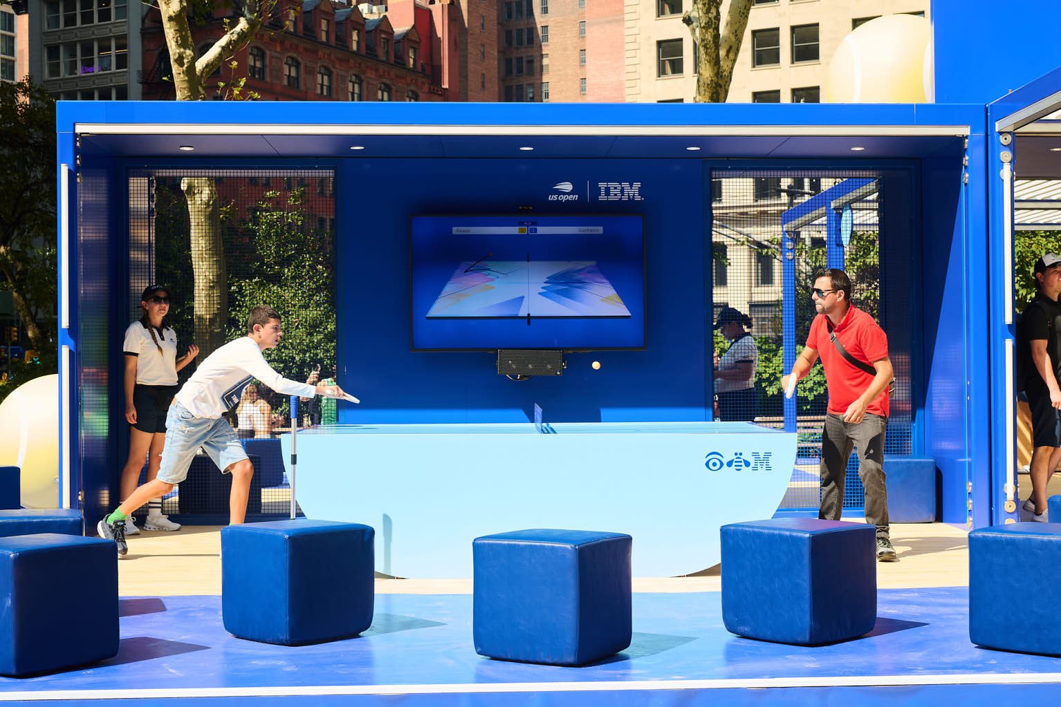 Two people playing table tennis at ibm's brand activation in Madison square park 