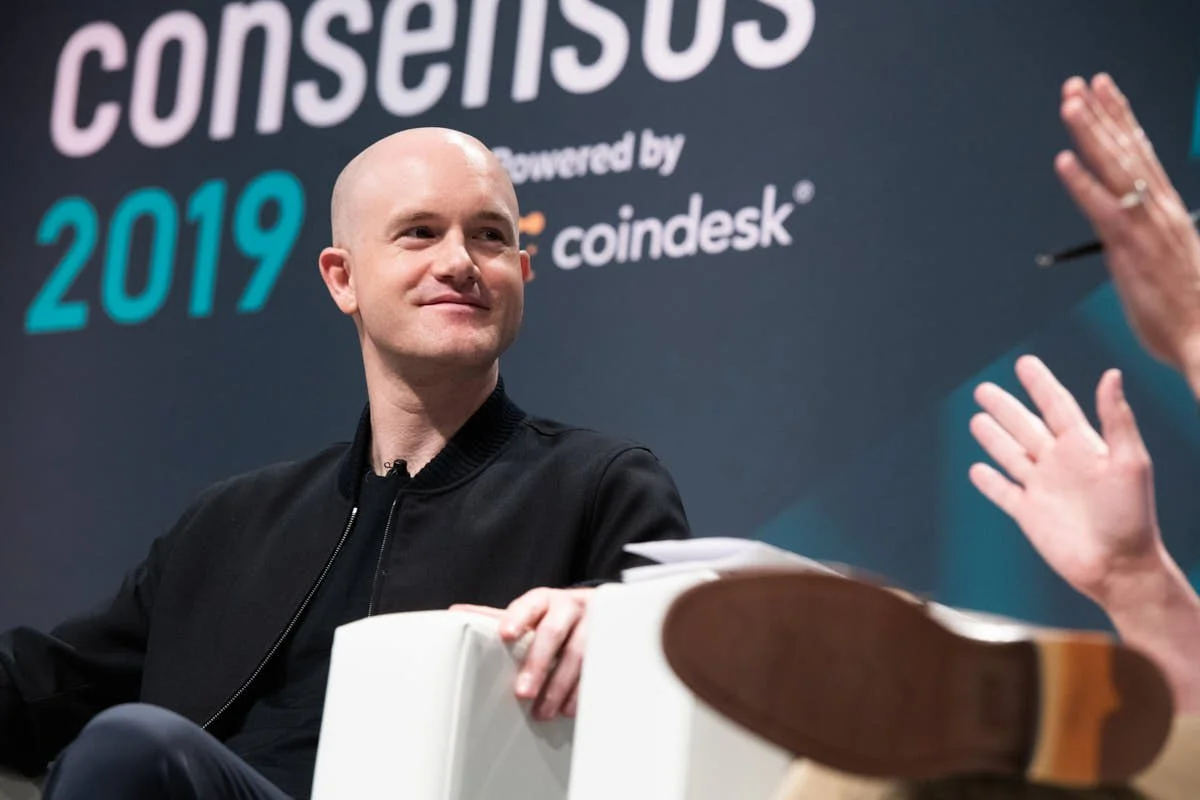 Event Photography of Brian Armstrong  onstage smiling at consensus 2019, nyc