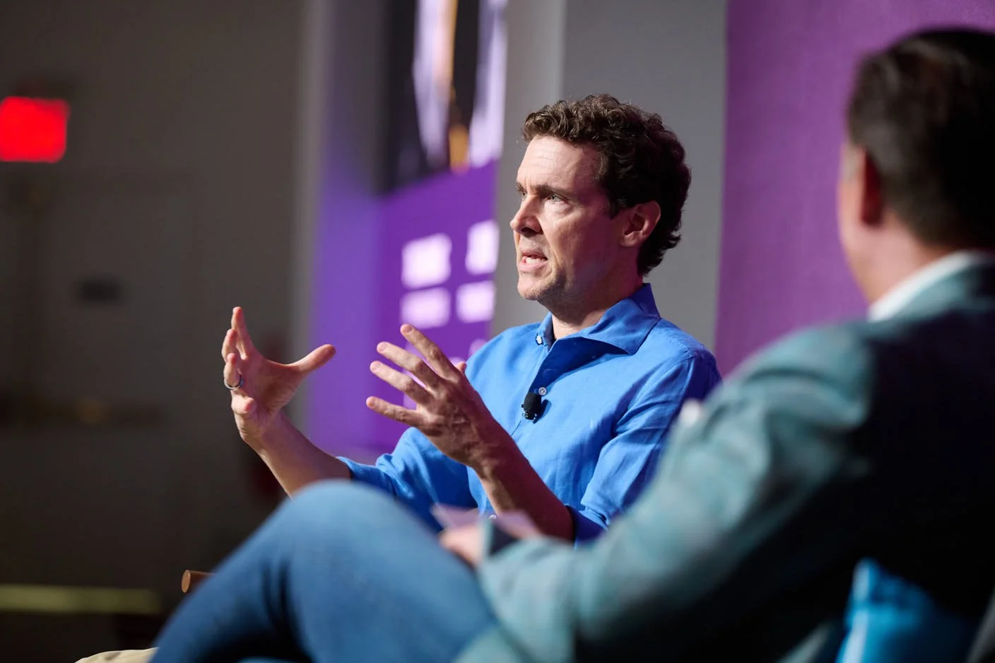 Jay Livingston onstage giving closing remarks at Iterable NYC, 2025