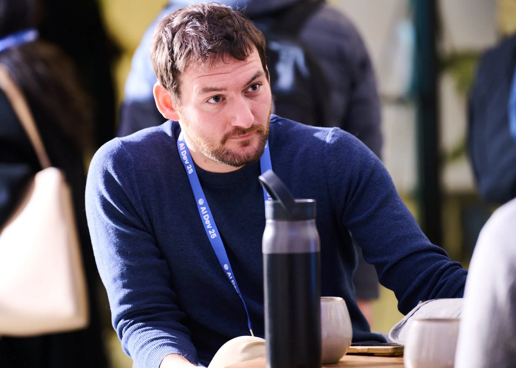 Event Photograph of a man looking engaged at Deeplearning.AI Conference, New York New York
