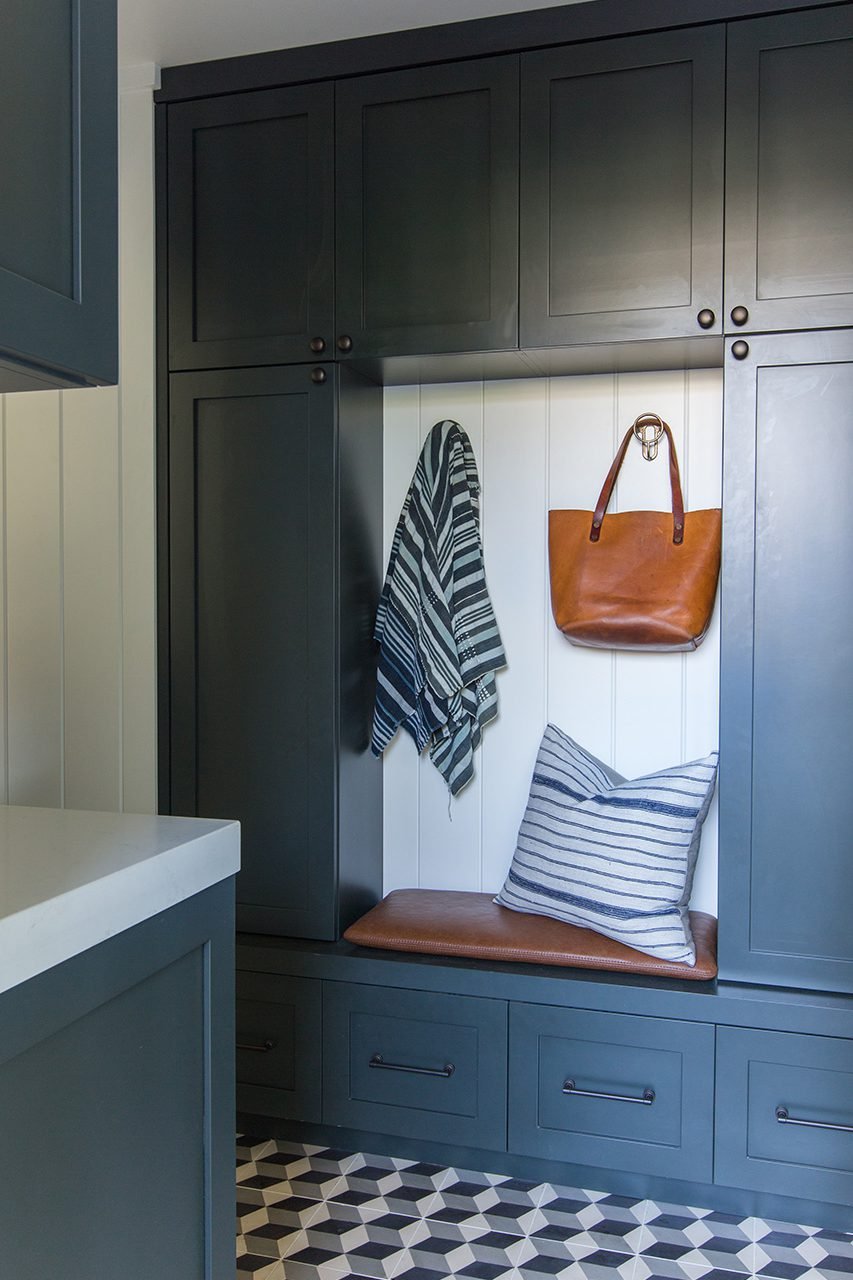 CUSTOM SHAKER-STYLE CABINETS BRING CHARACTER TO STORAGE SPACES.