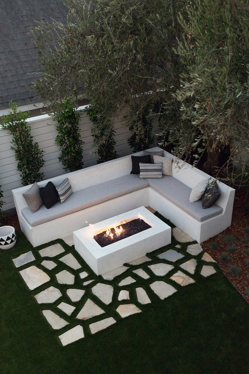 THE BACK GARDEN FEATURES DROUGHT-RESISTANT LANDSCAPING AND A FIRE-PIT.
