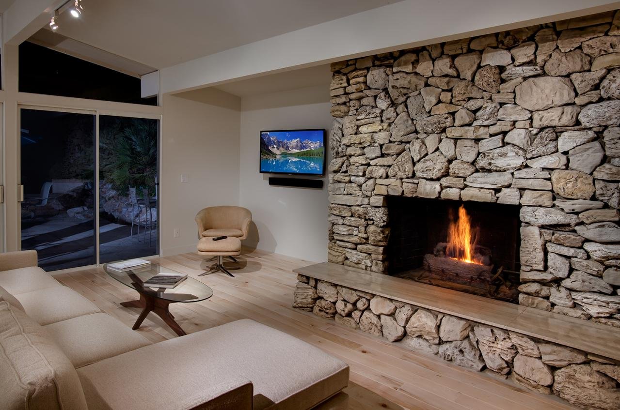 GDC MAINTAINED THE CLASSIC CUSTOM ROCK FIREPLACE, WHILE REPLACING THE FLOORING IN THE MAIN LIVING AREA.