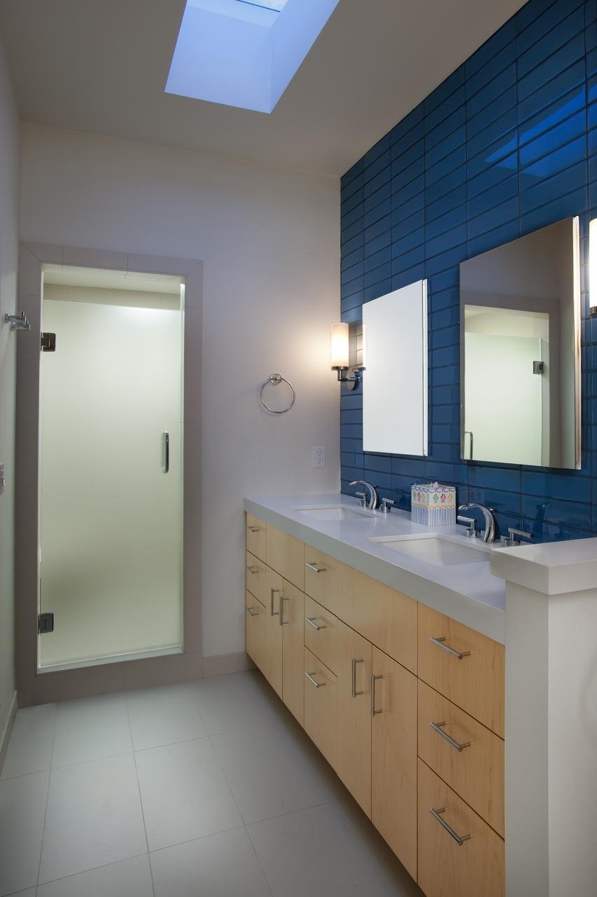 THE MASTER BATHROOM IS MODERN, YET CLASSIC, WITH A FLOATING CABINET AND RETRO-STYLE TILES.