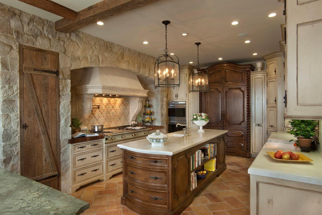 THE MEDITERRANEAN-STYLE KITCHEN FEATURES CUSTOM CABINETS BY INPLACE STUDIO, MARBLE COUNTERTOPS AND RECLAIMED FRENCH STONE.