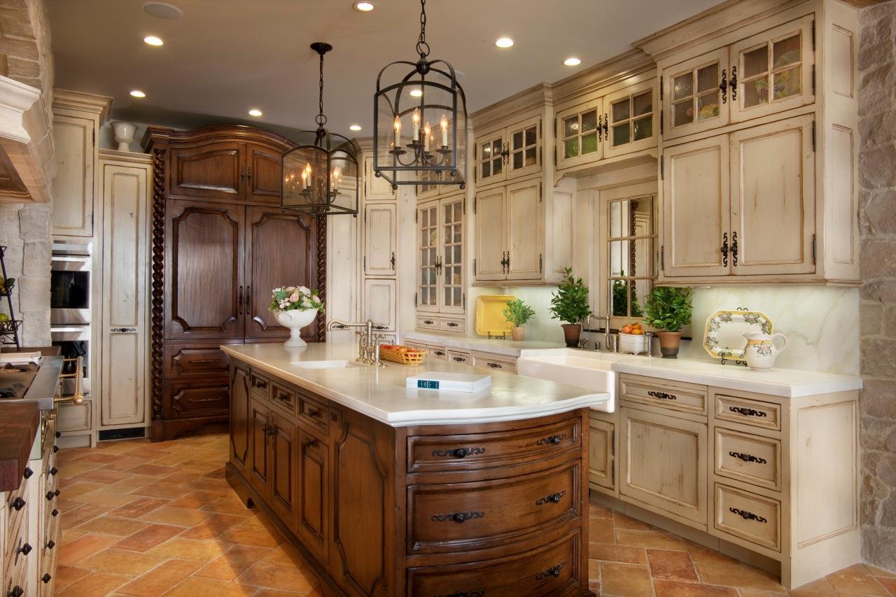 THE WOOD USED IN THE CABINETS THROUGHOUT THE KITCHEN WAS DISTRESSED TO MATCH THE RECLAIMED STONE AND MARBLE.