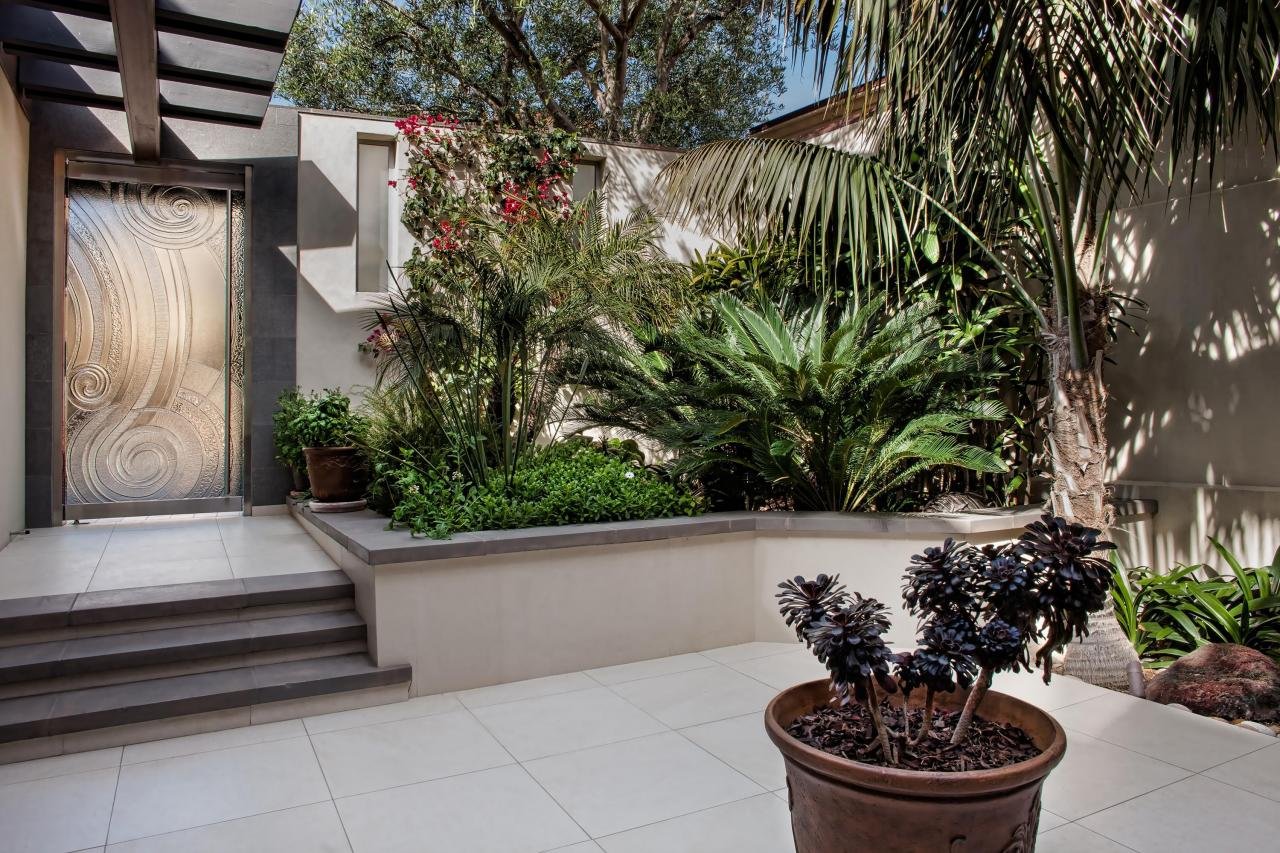 THE 2 FOOT-BY-2-FOOT BASALT TILES RUN FROM THE EXTERIOR COURTYARD INTO THE INTERIOR KITCHEN.