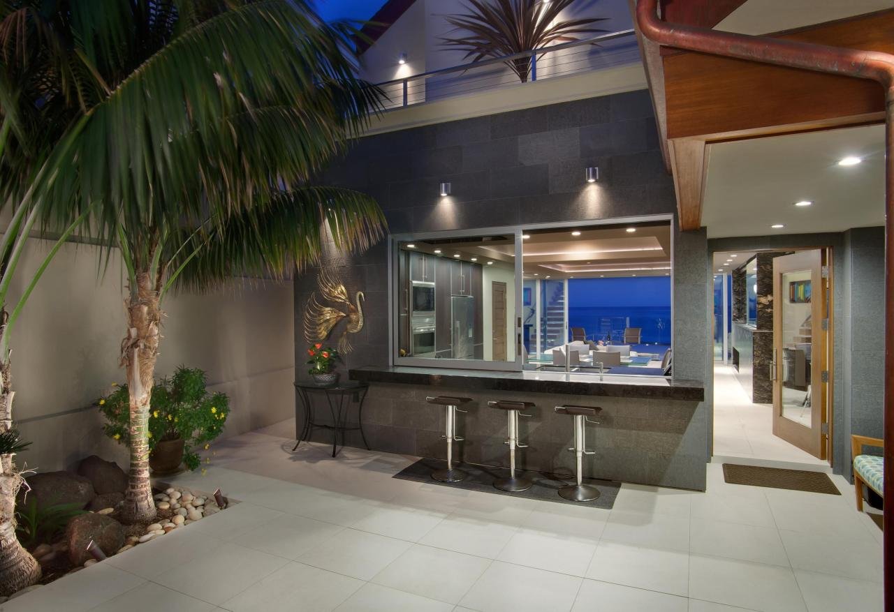 THE KITCHEN FEATURES AN EXTERIOR BAR PASS-THROUGH FOR ENTERTAINING.