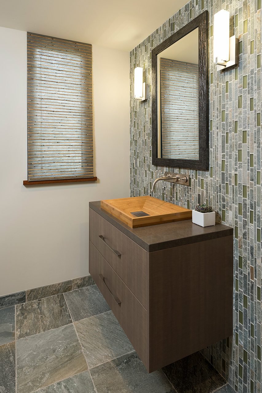 A FLOATING BATHROOM VANITY AND CUSTOM SINK ARE TWO EXAMPLES OF GDC’S CUSTOM WOODWORKING.