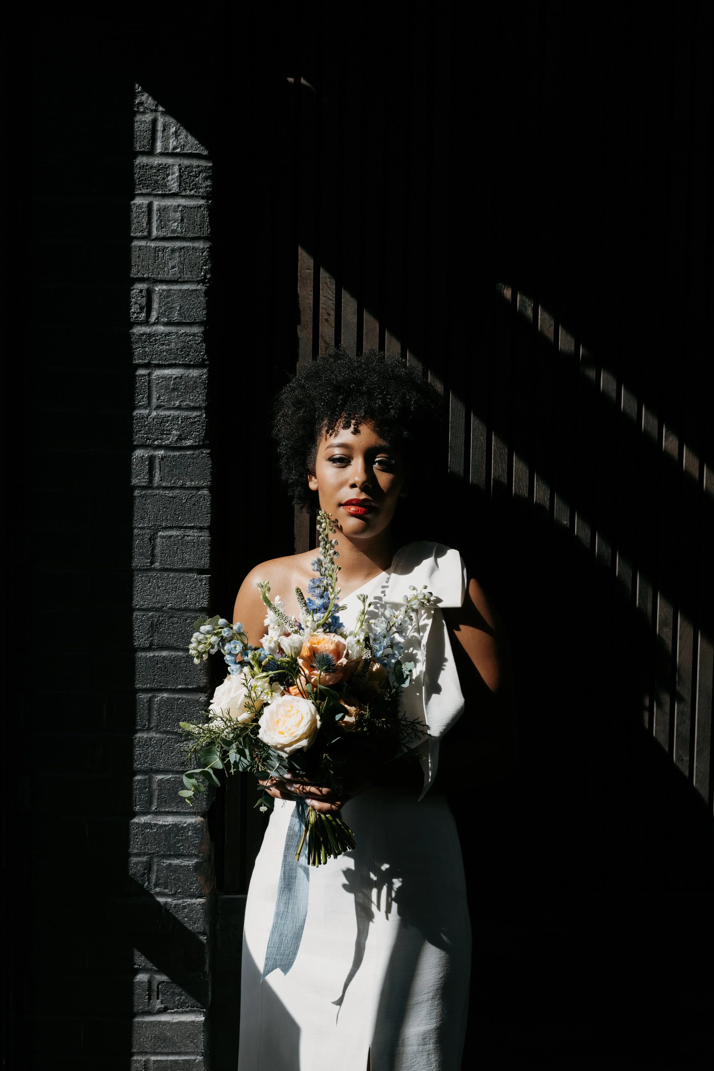 bride standing with bouquet made by a wedding florist in NYC