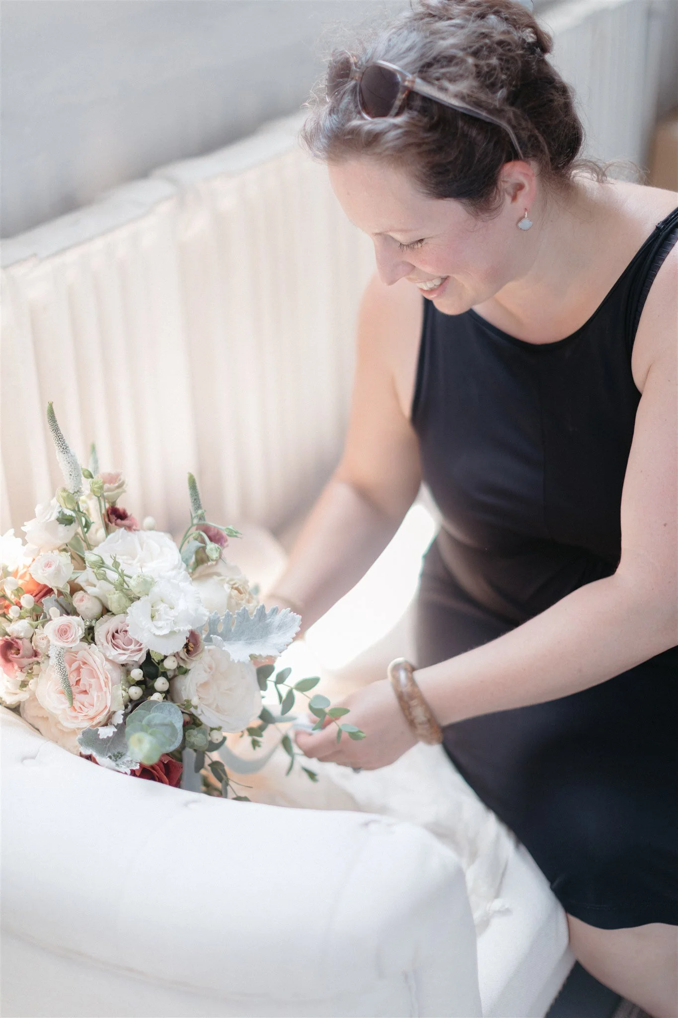 florist in Weehawken NJ setting up a bridal bouquet for photos