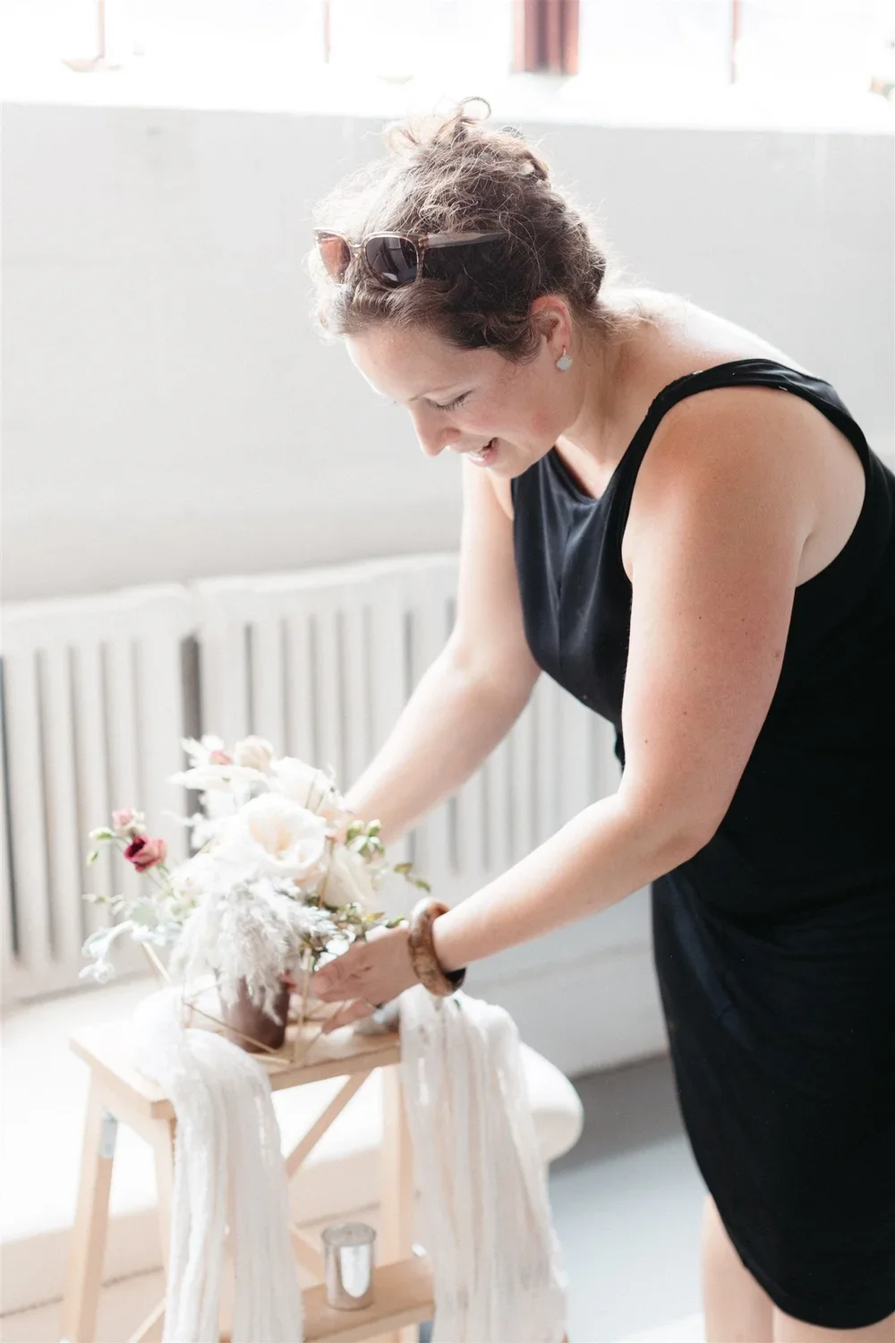 Jersey City florist setting up a floral display in a home