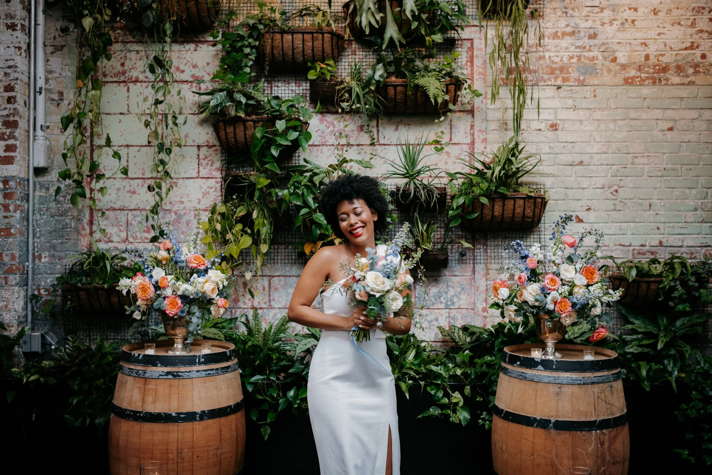 brides standing with bouquet and centerpieces designed by a wedding florist in NYC