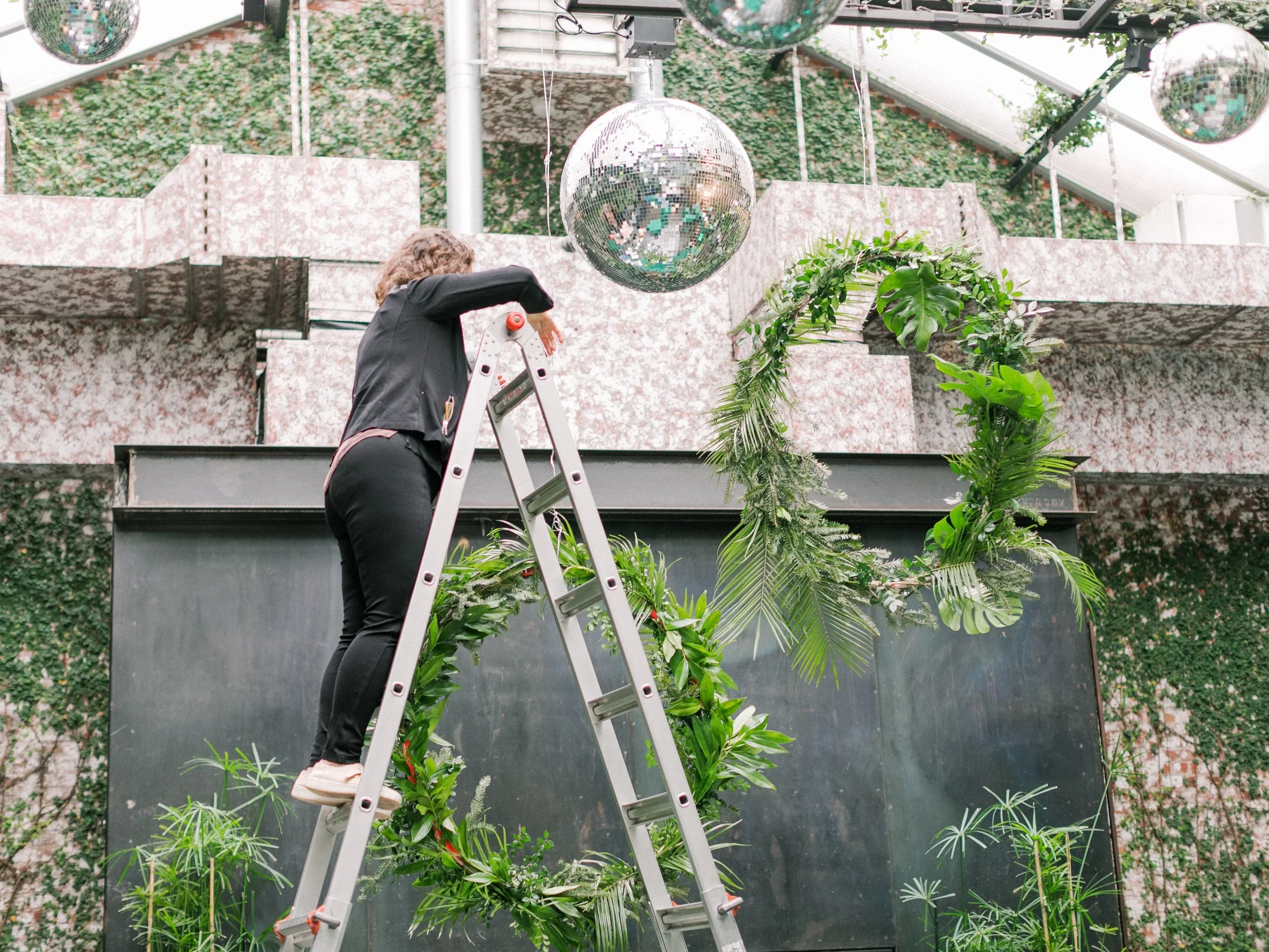 jersey city florist on ladder setting up a floral installation
