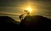 Person jumping at sunset on a rocky landscape