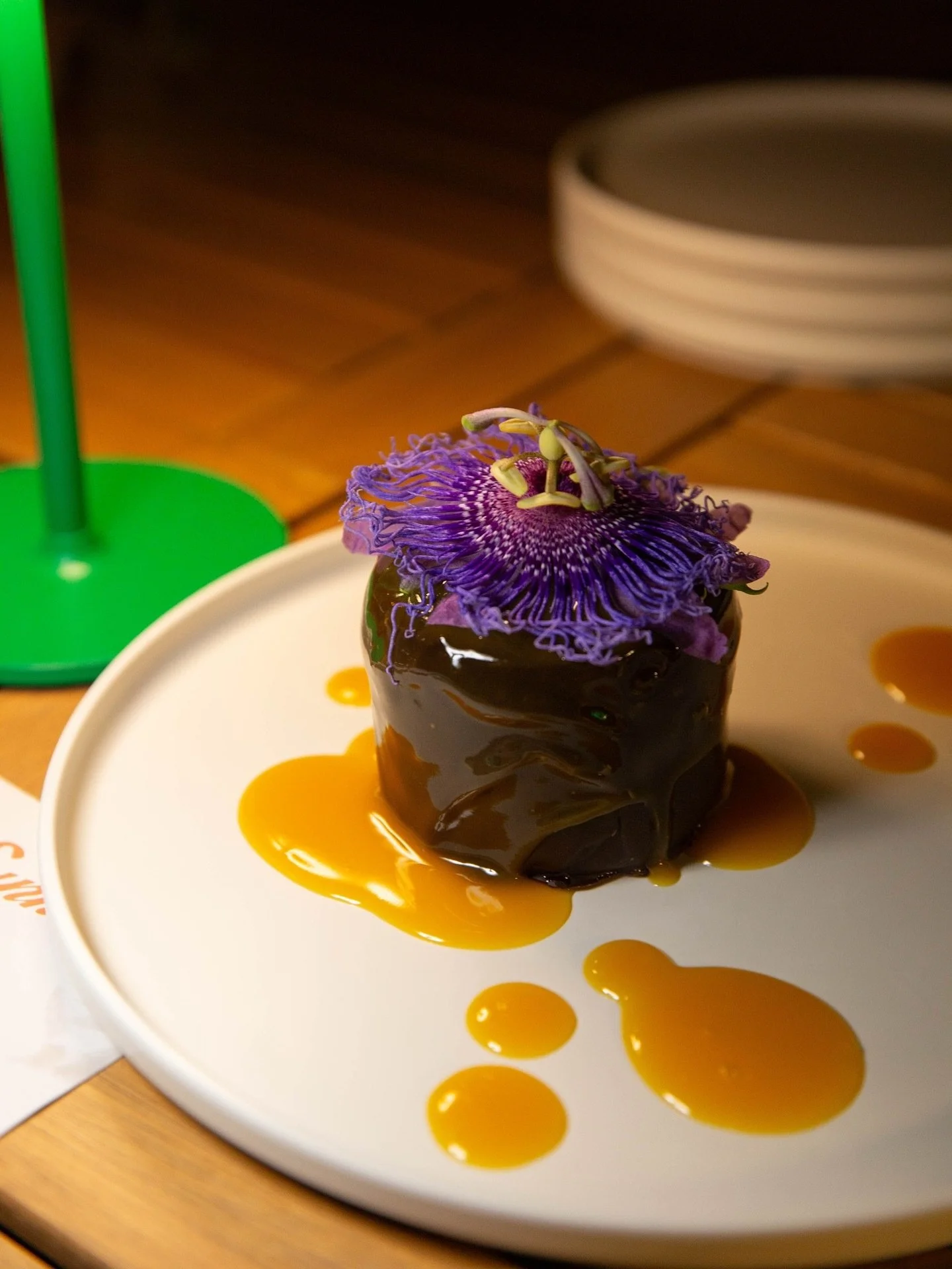 End the night on a high note. Double Trouble &mdash; layers of cheesecake and chocolate cake, dipped in ganache and finished with a bright passion fruit drizzle.