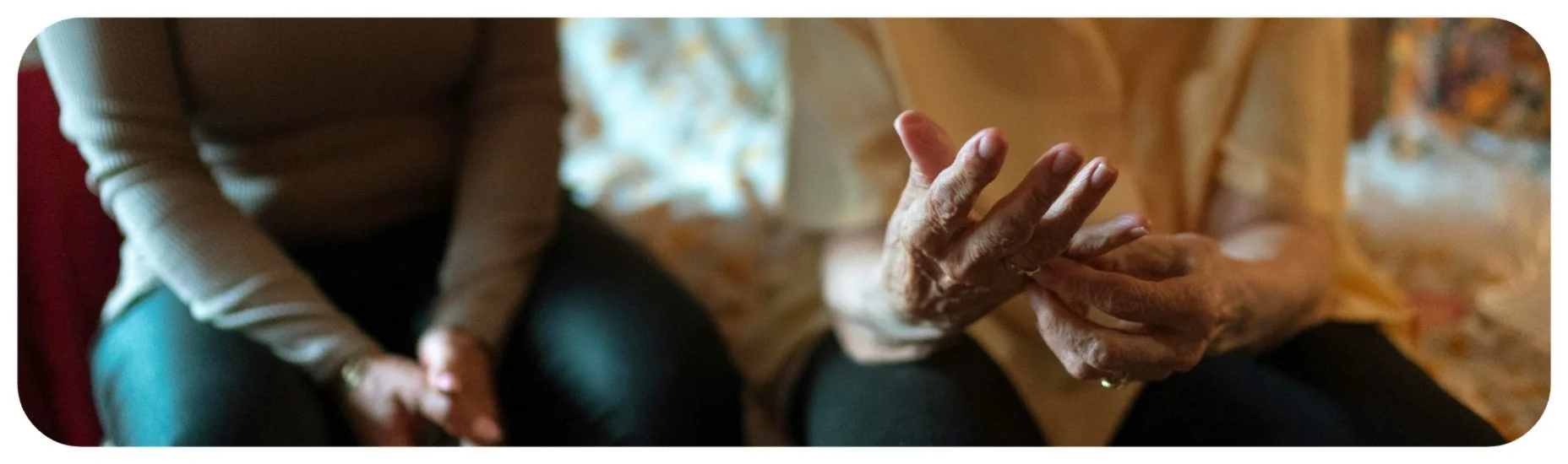 Elderly person sitting with a caregiver, representing Iowa nursing home abuse and neglect cases.