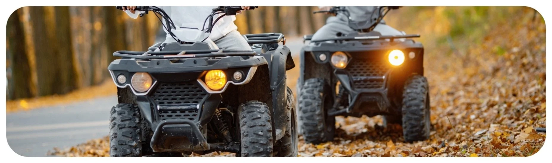 Two riders driving ATVs through a wooded trail, representing Iowa ATV and UTV accident injury cases.