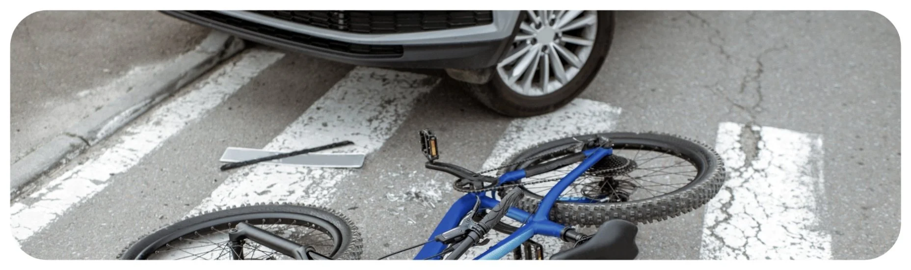 Bicycle lying in a crosswalk after a collision with a vehicle, representing Iowa bicycle accident injury cases.