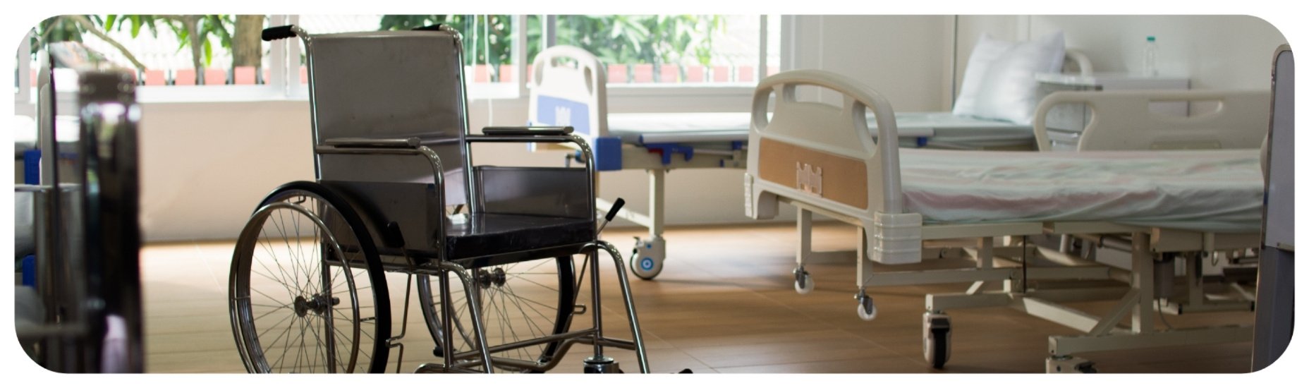 Empty wheelchair and hospital bed in nursing facility room, illustrating neglect concerns in Iowa nursing homes.